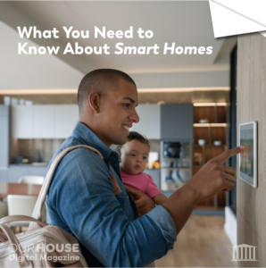 Man holding a baby programming a smart home screen 